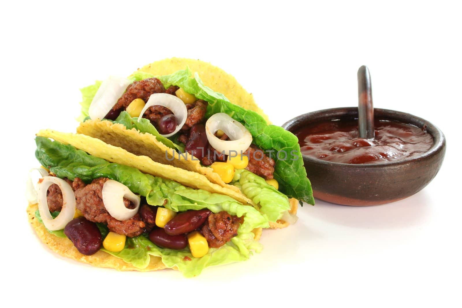 Mexican tacos with ground beef, lettuce, red kidney beans and corn on a white background