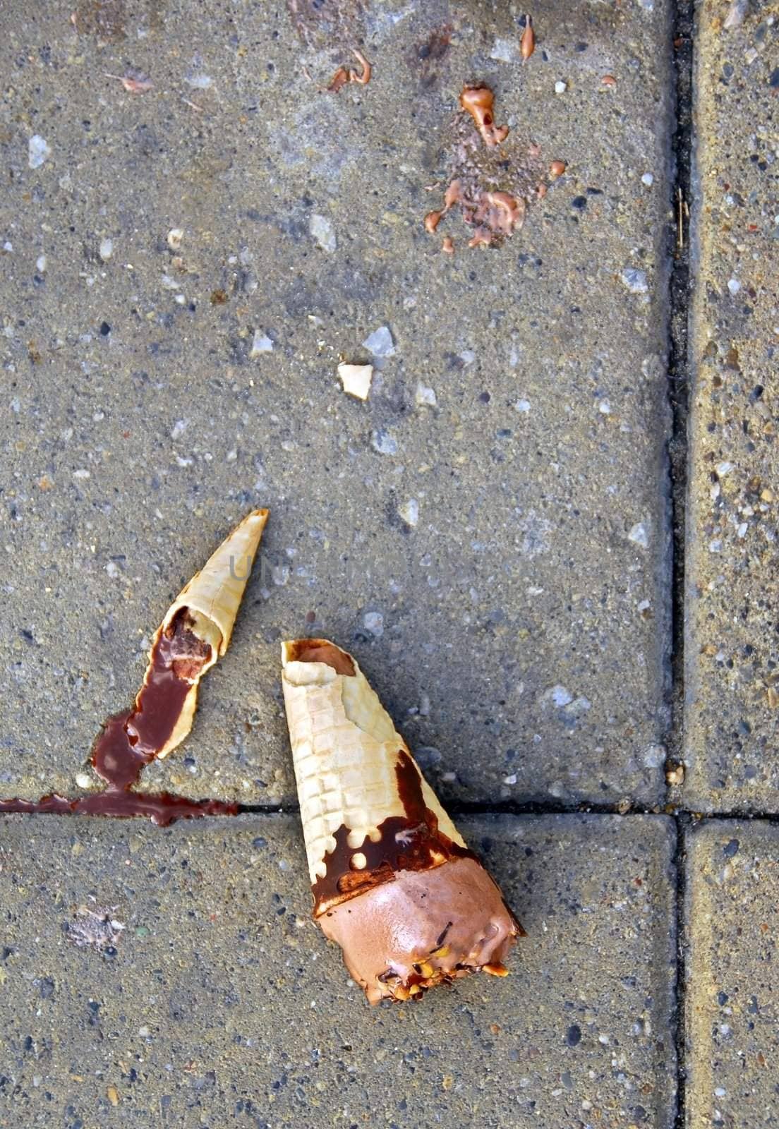 dropped broken chocolate ice-cream melting on street