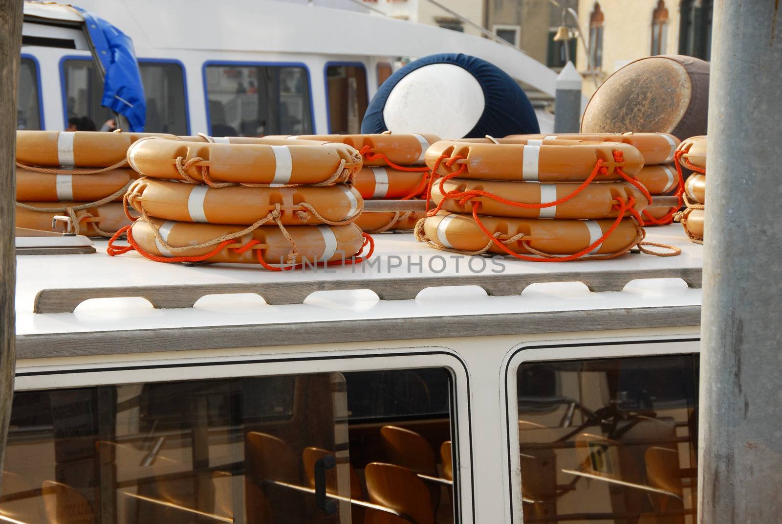 stacks of life belts on boat, rescue equipment