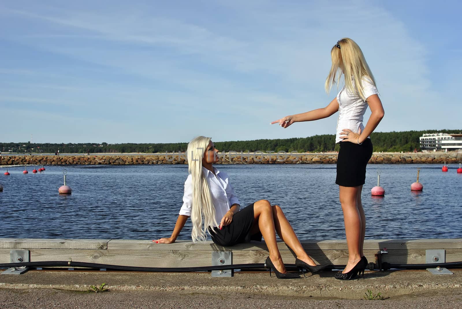 Girl arguing with another girl on the pier