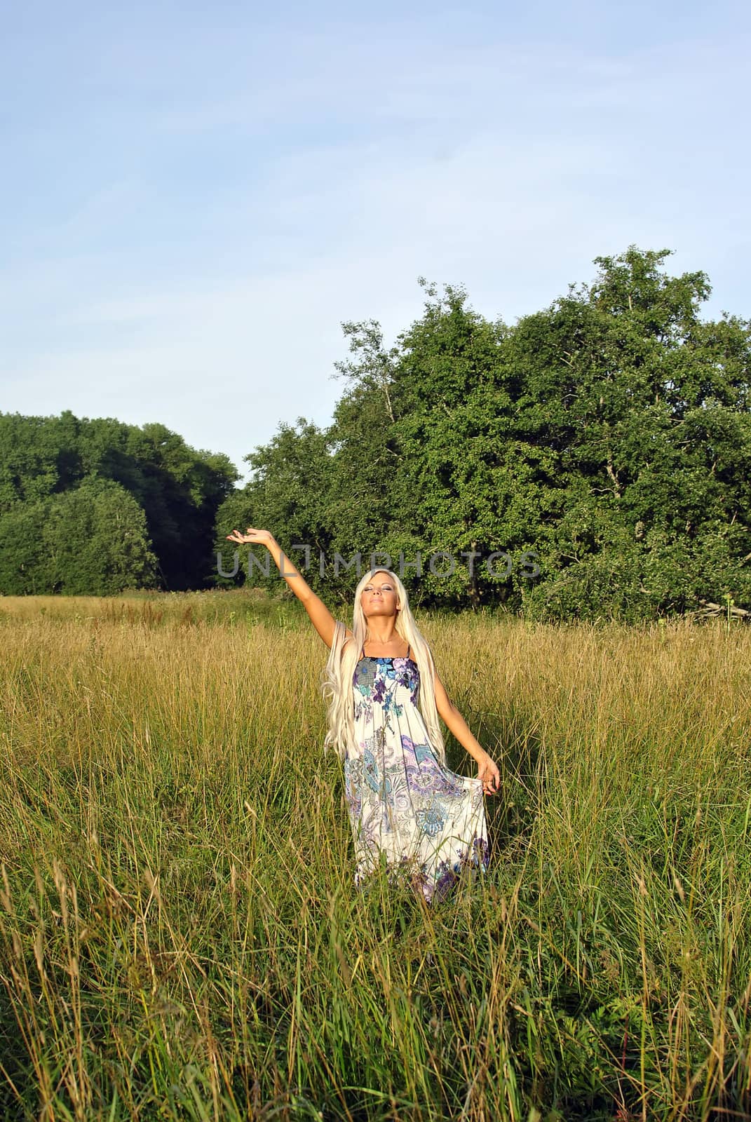 Blonde girl alone in field. Freedom.