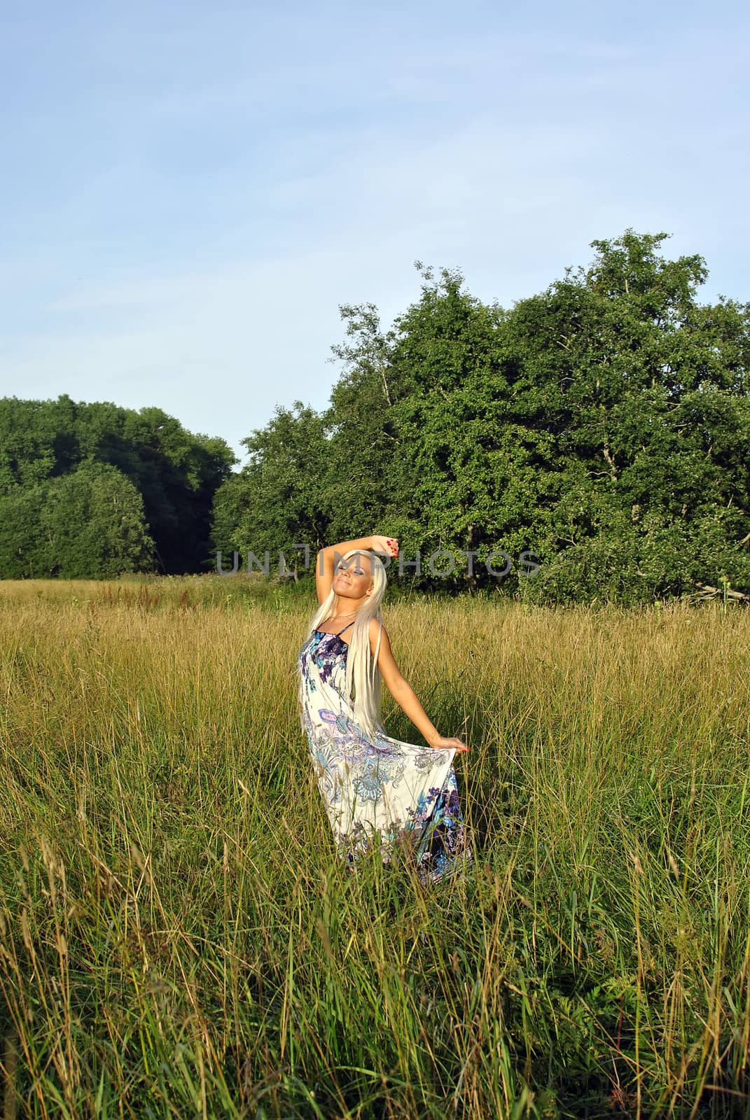 Blonde girl alone in field. Freedom.