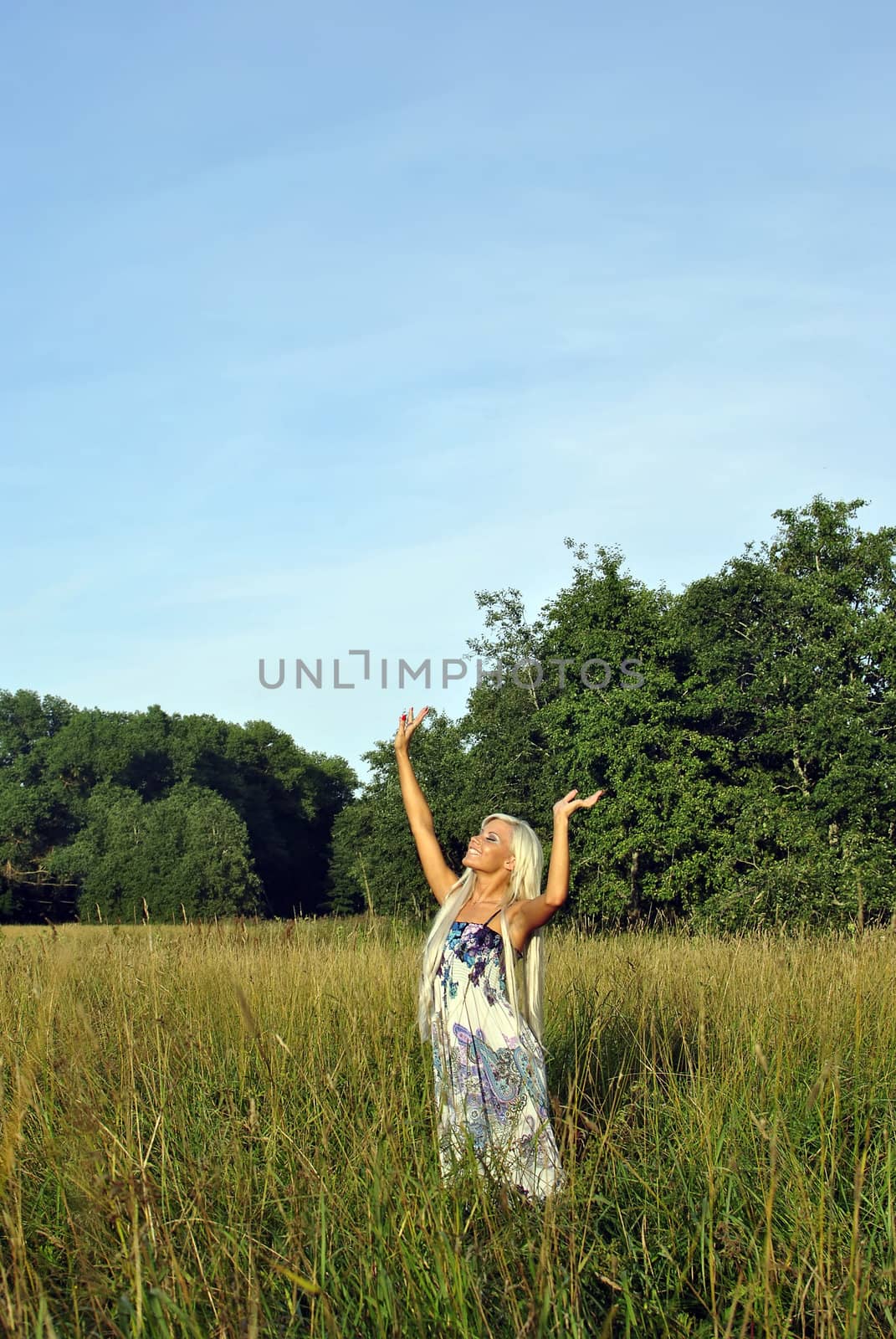 Blonde girl alone in field. Freedom.