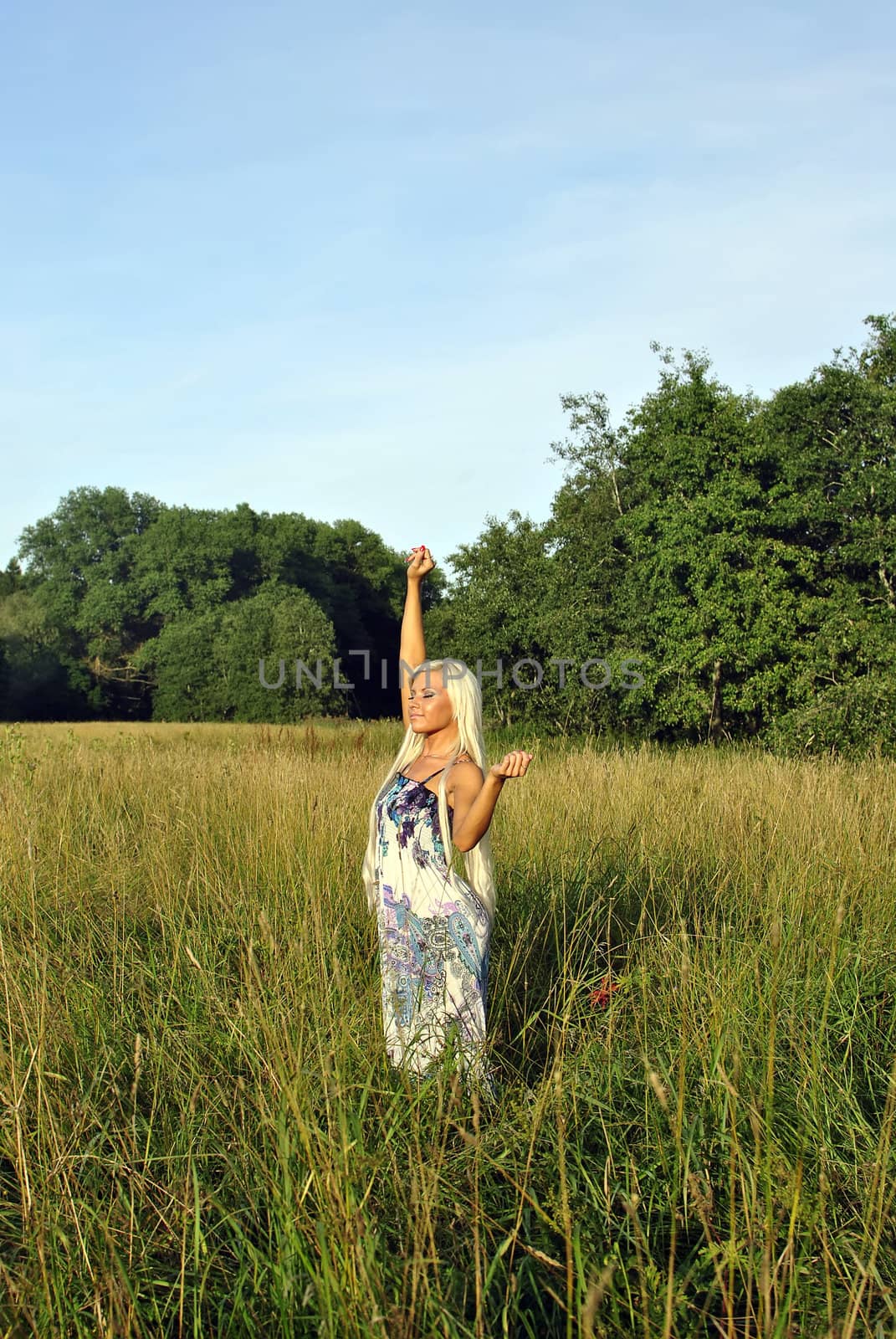 Blonde girl alone in field. Freedom.