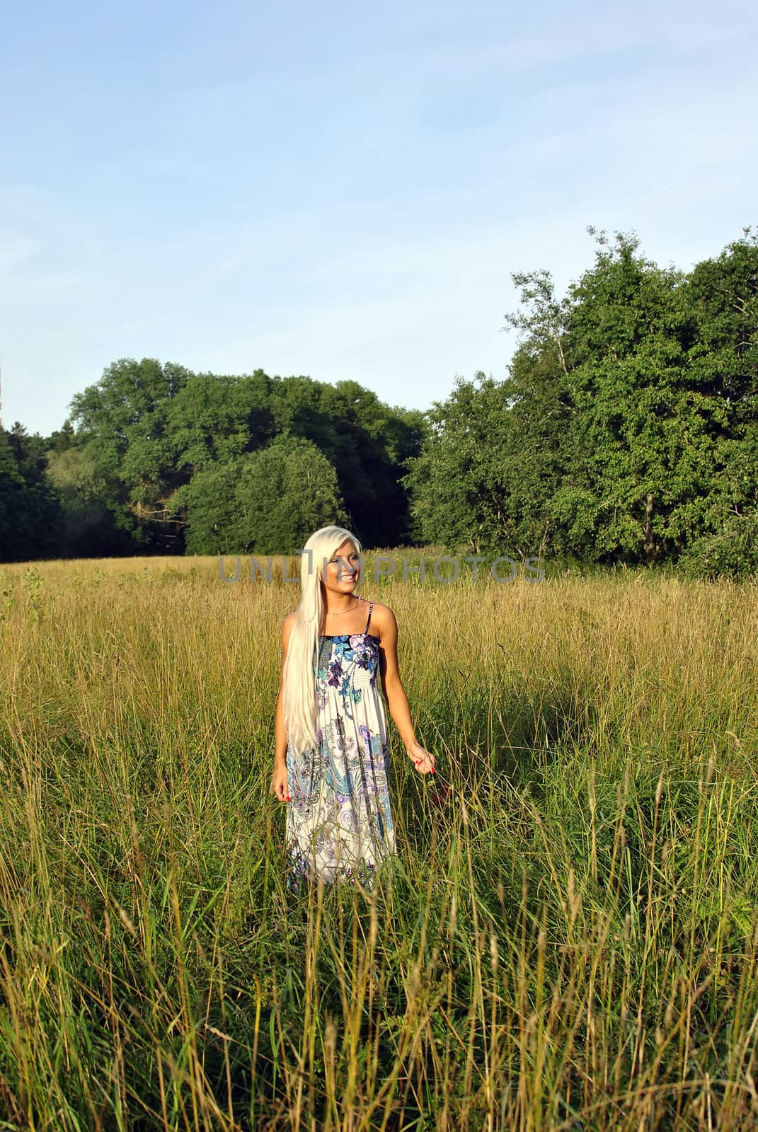 Blonde girl alone in field. Freedom.