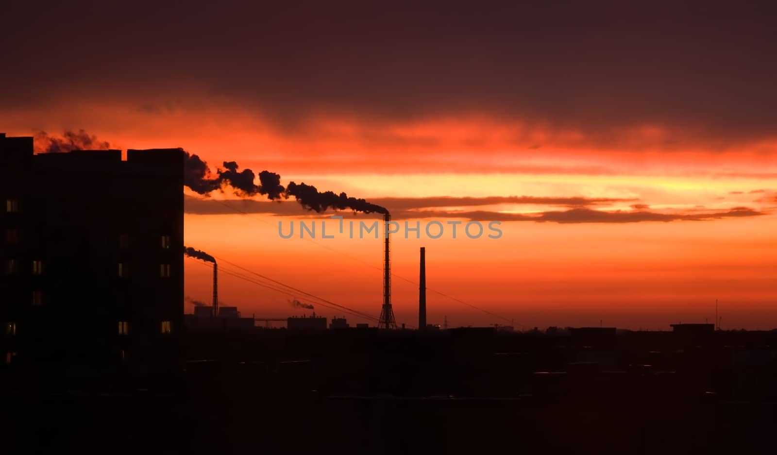  photograph of industrial buildings at sunset sky 
