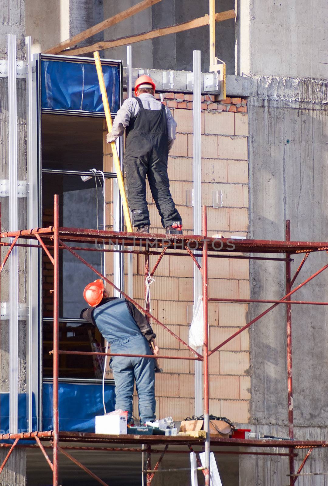A construction worker on a high wall