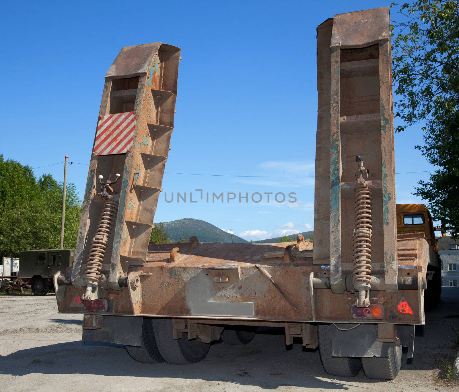 Tractor trucks against the blue sky. Rear view.