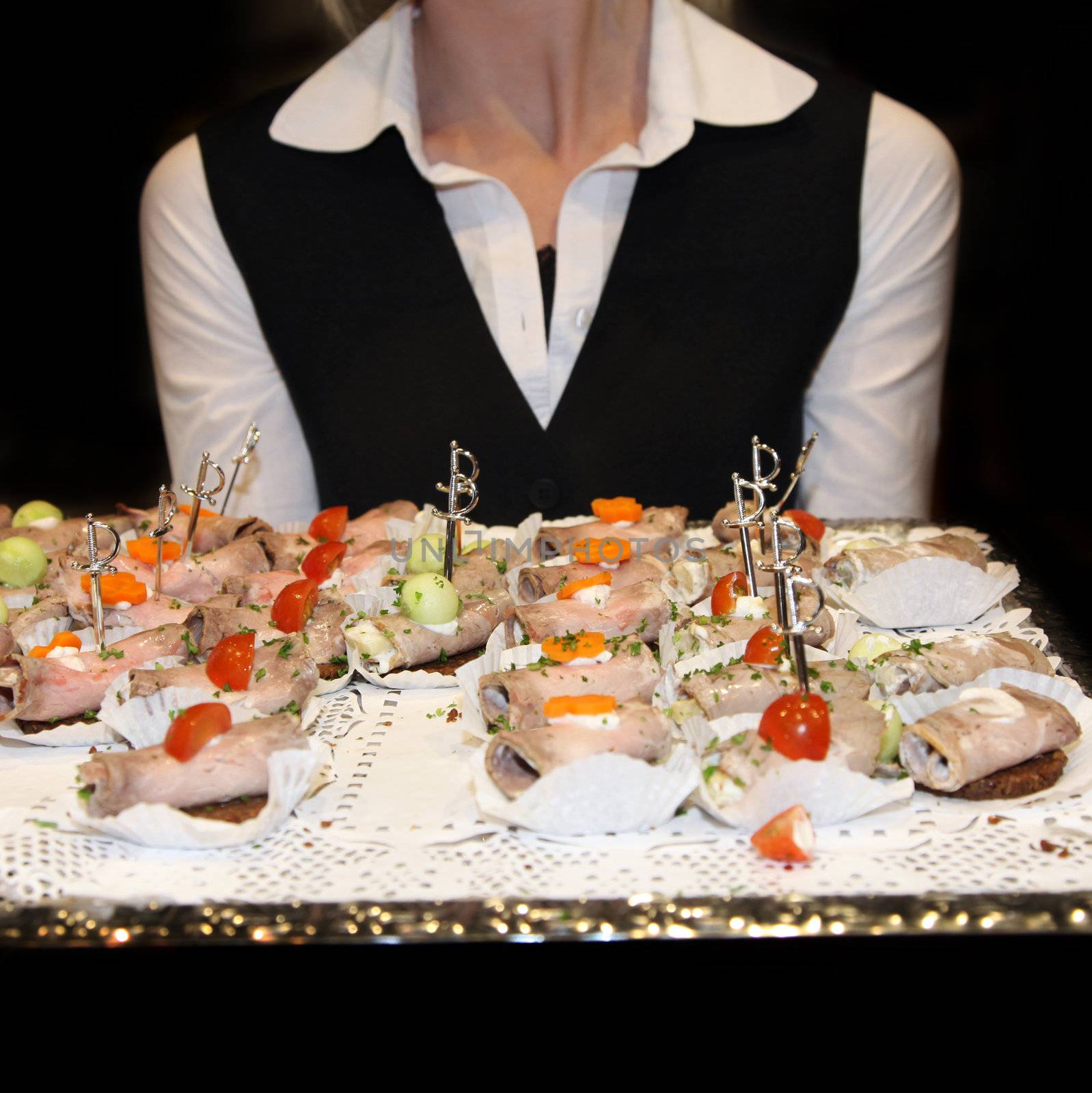 Waitress serving finger food. by Farina6000