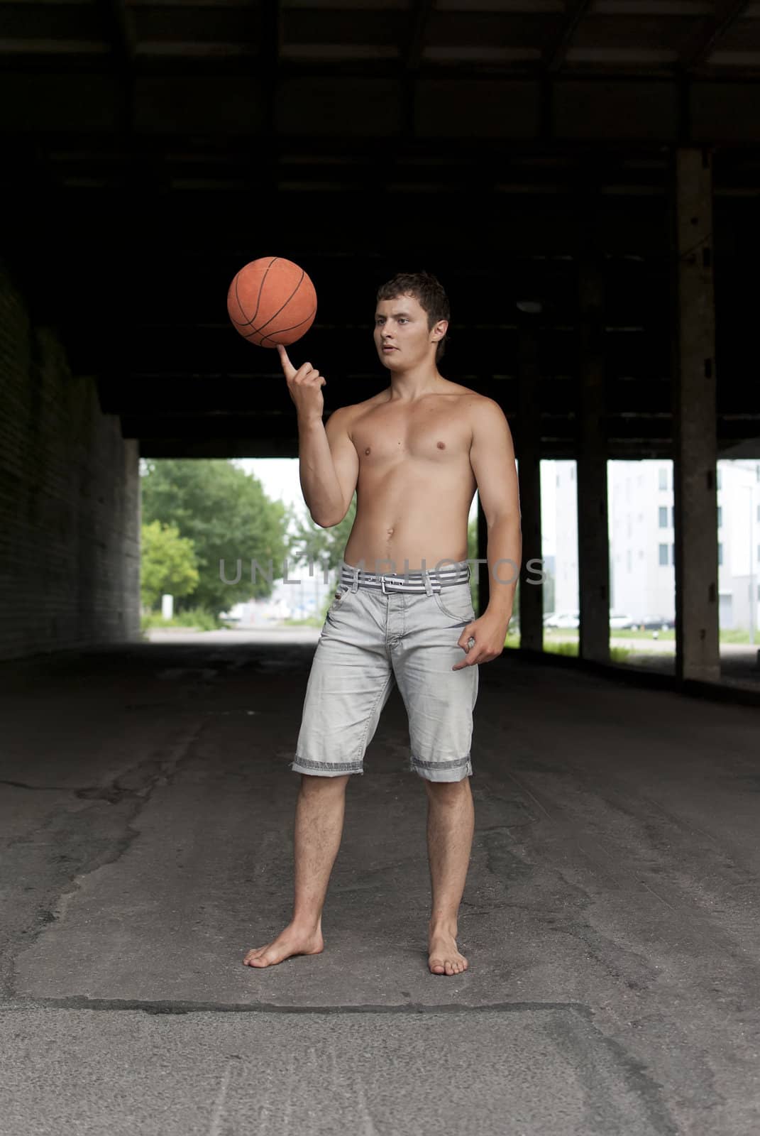 Guy with torso holding basketball on his finger