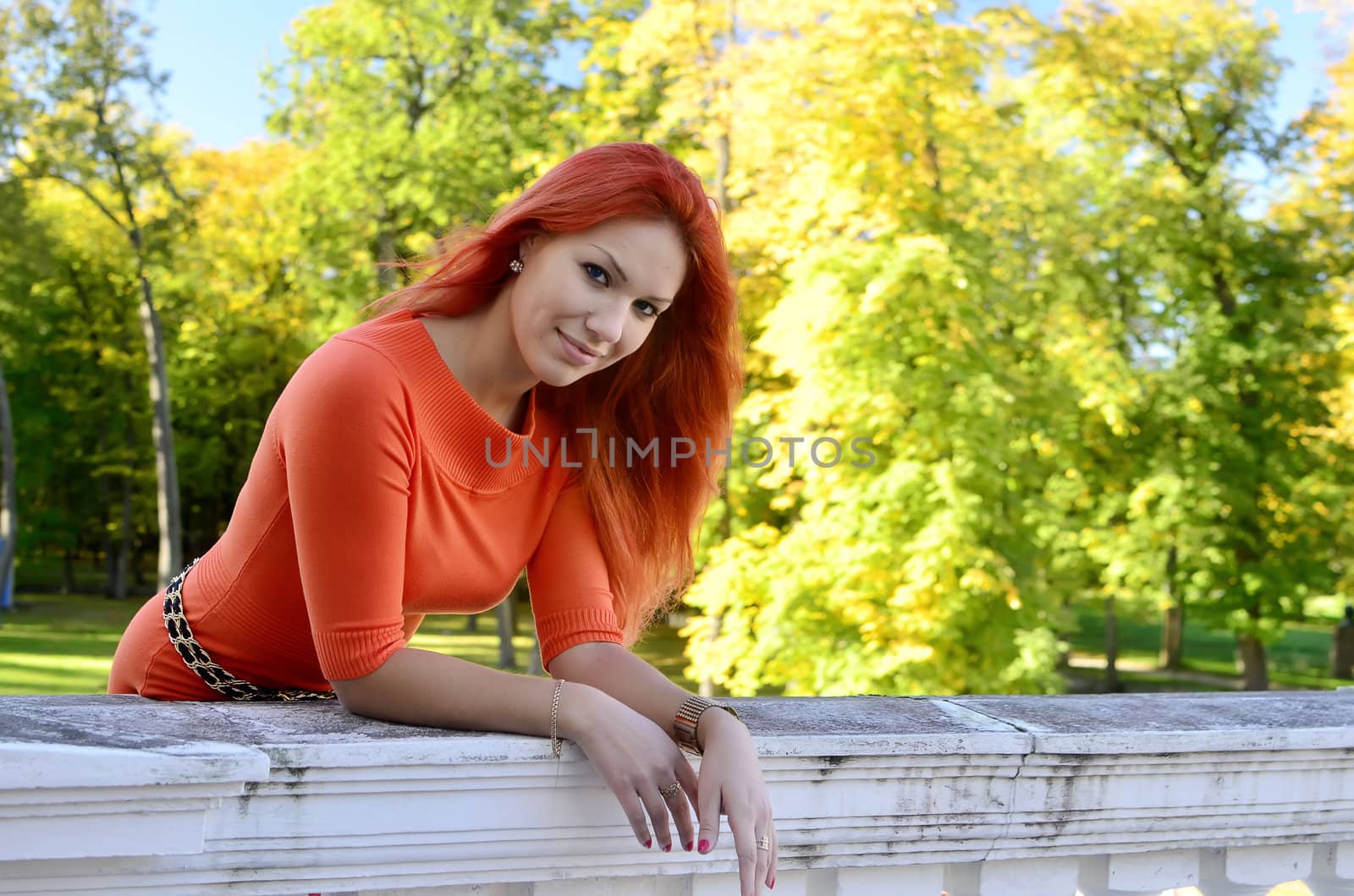 Redhead girl standing at the railing