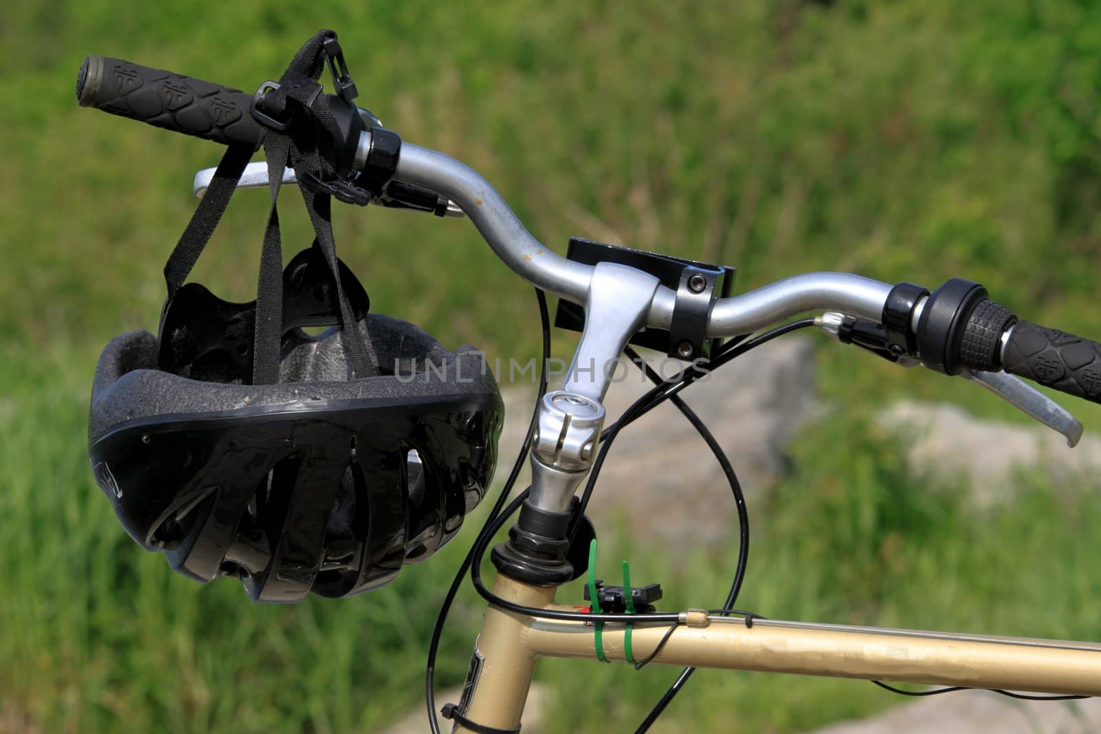 Bike helmet hanging on bicycle handle bar