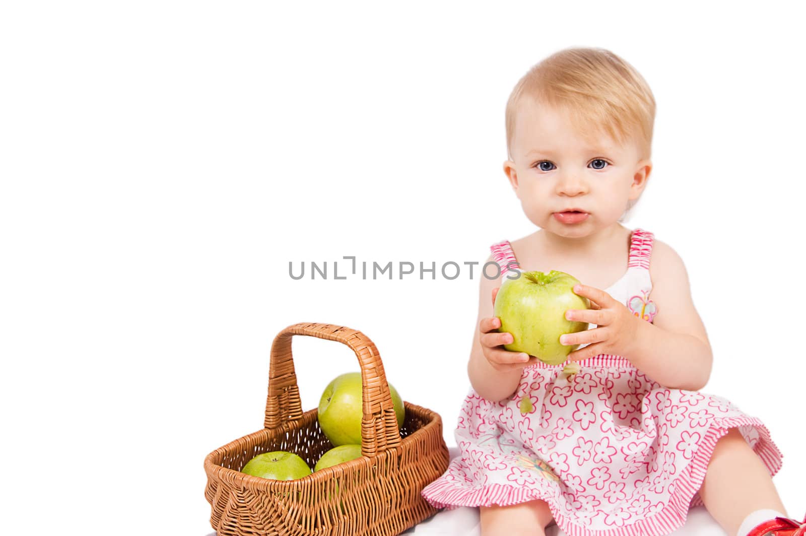 Baby girl with basket and apples over white