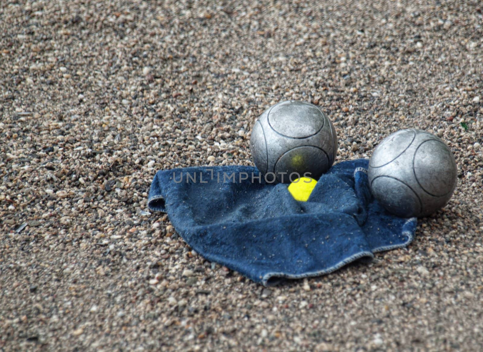 Ball French game petanque with two balls and a towel on the ground