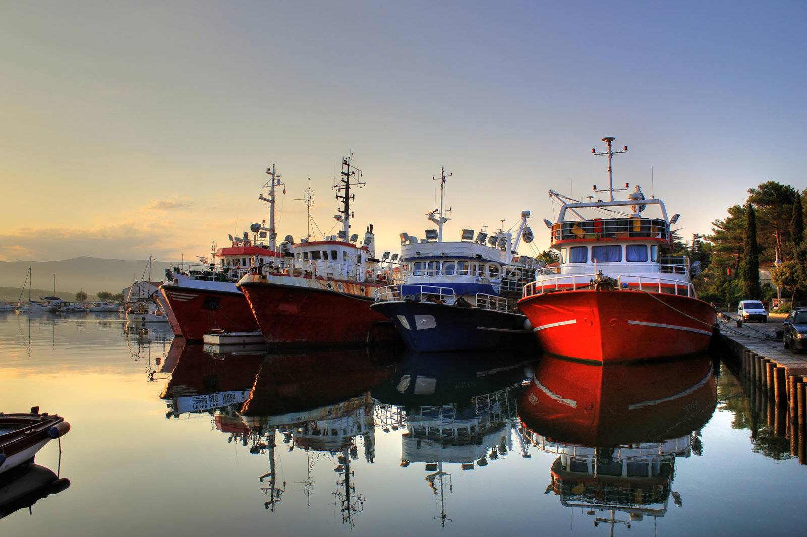 Fishing boats in harbor on early morning, calm sea, Island of Krk, Croatia