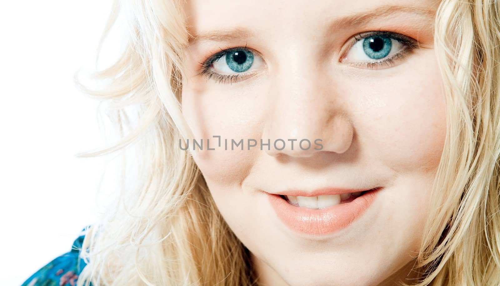 Studio portrait of a blond young lady with strong blue eyes