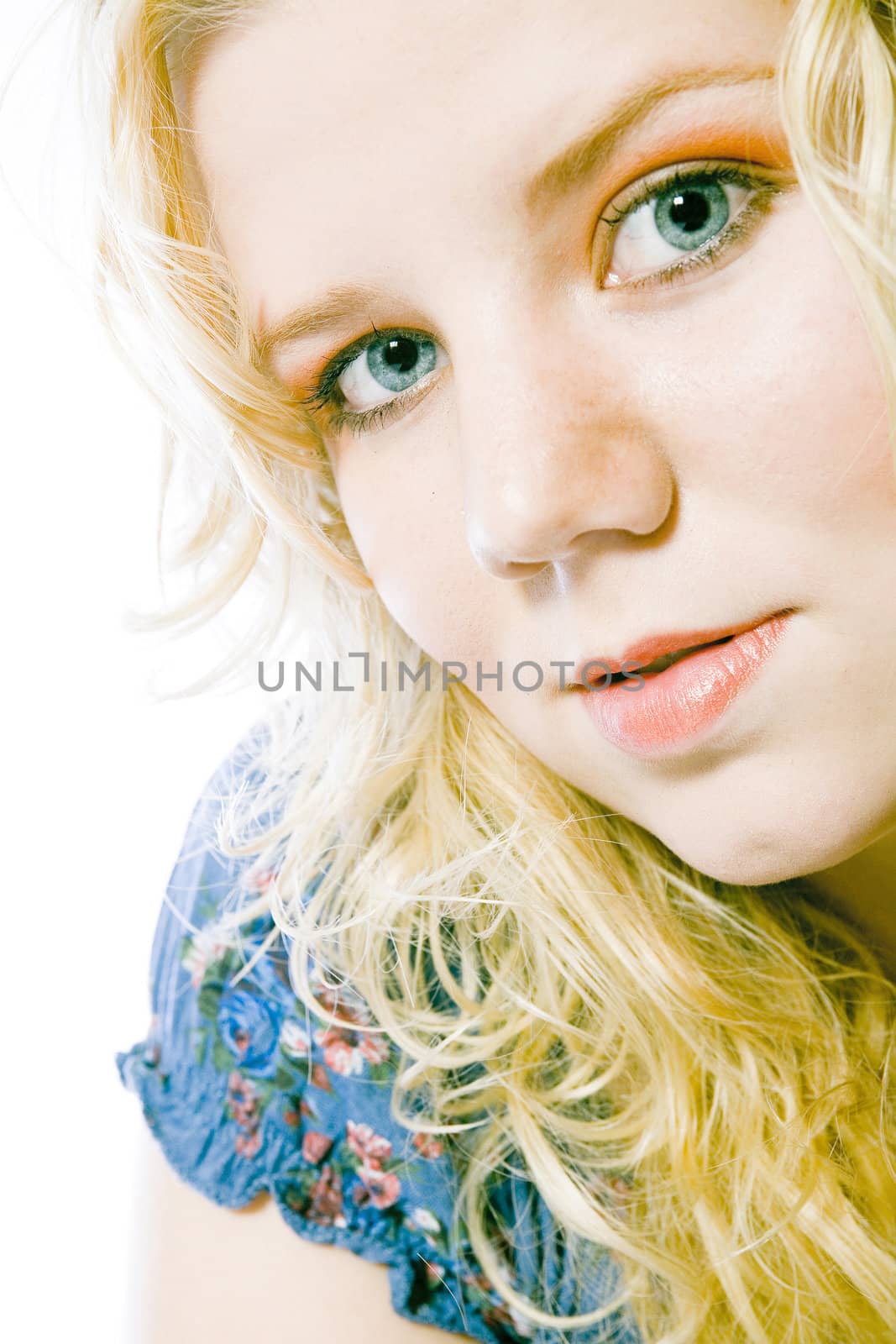 Studio portrait of a blond young lady with yellow blond hair and blue eyes