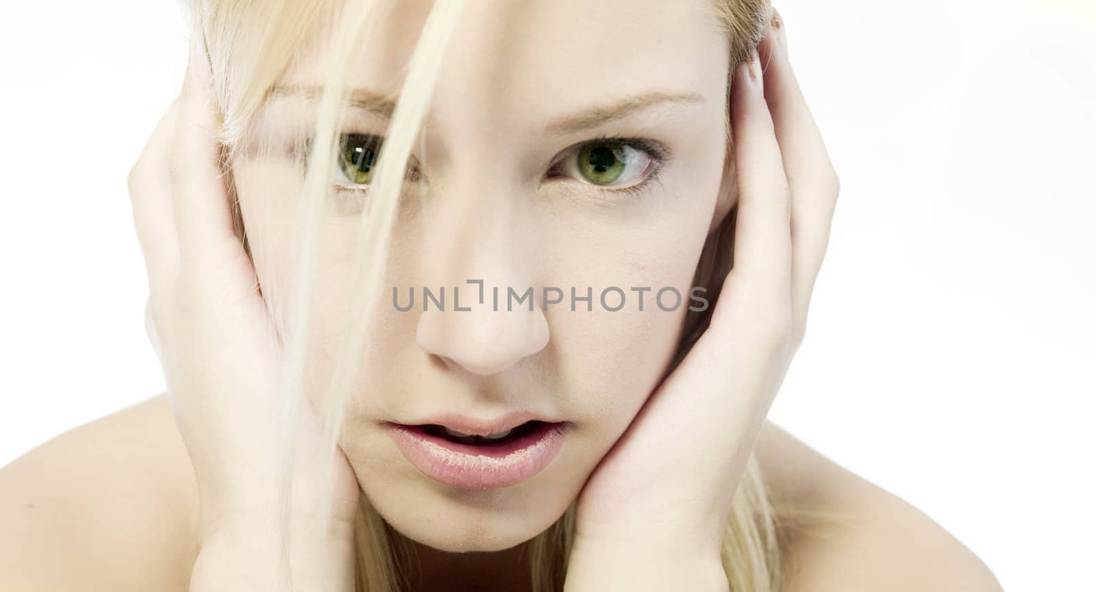 Studio portrait of a young blond woman with green eyes