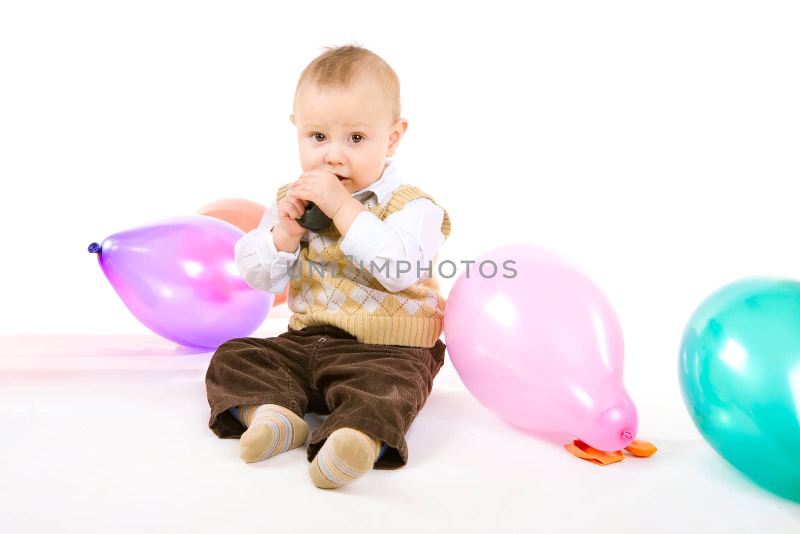 boy of one year old tries to inflate a balloon