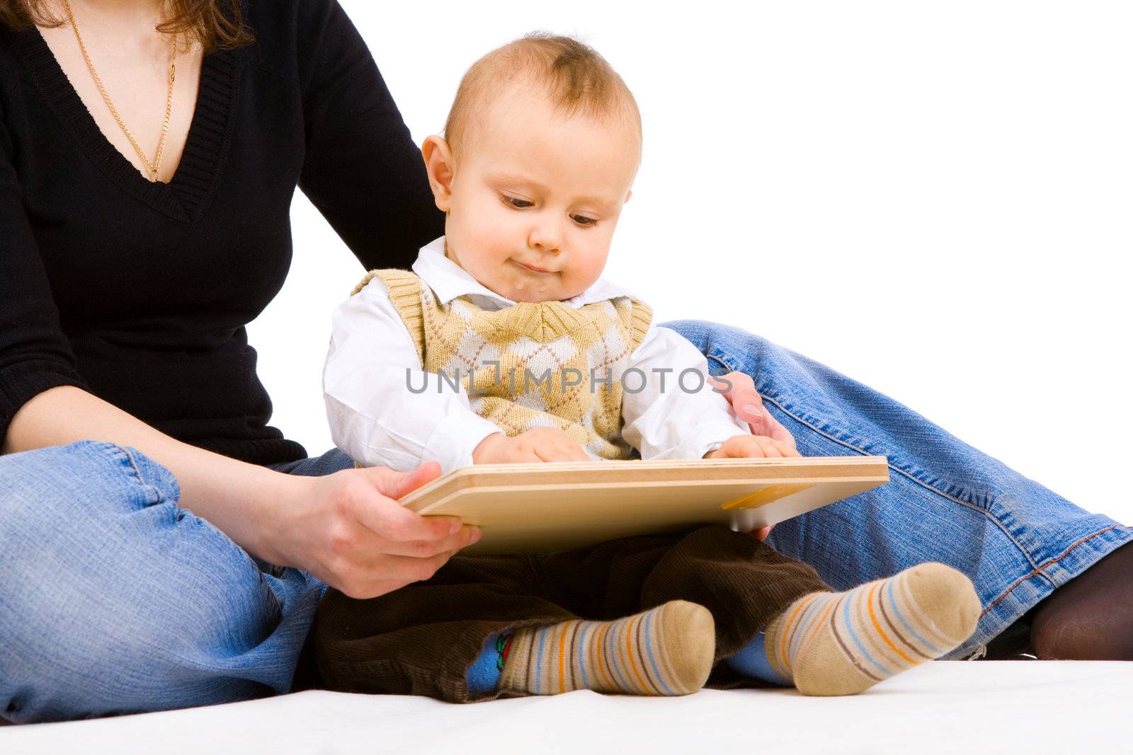 small boy and his mother sit on the floor and play