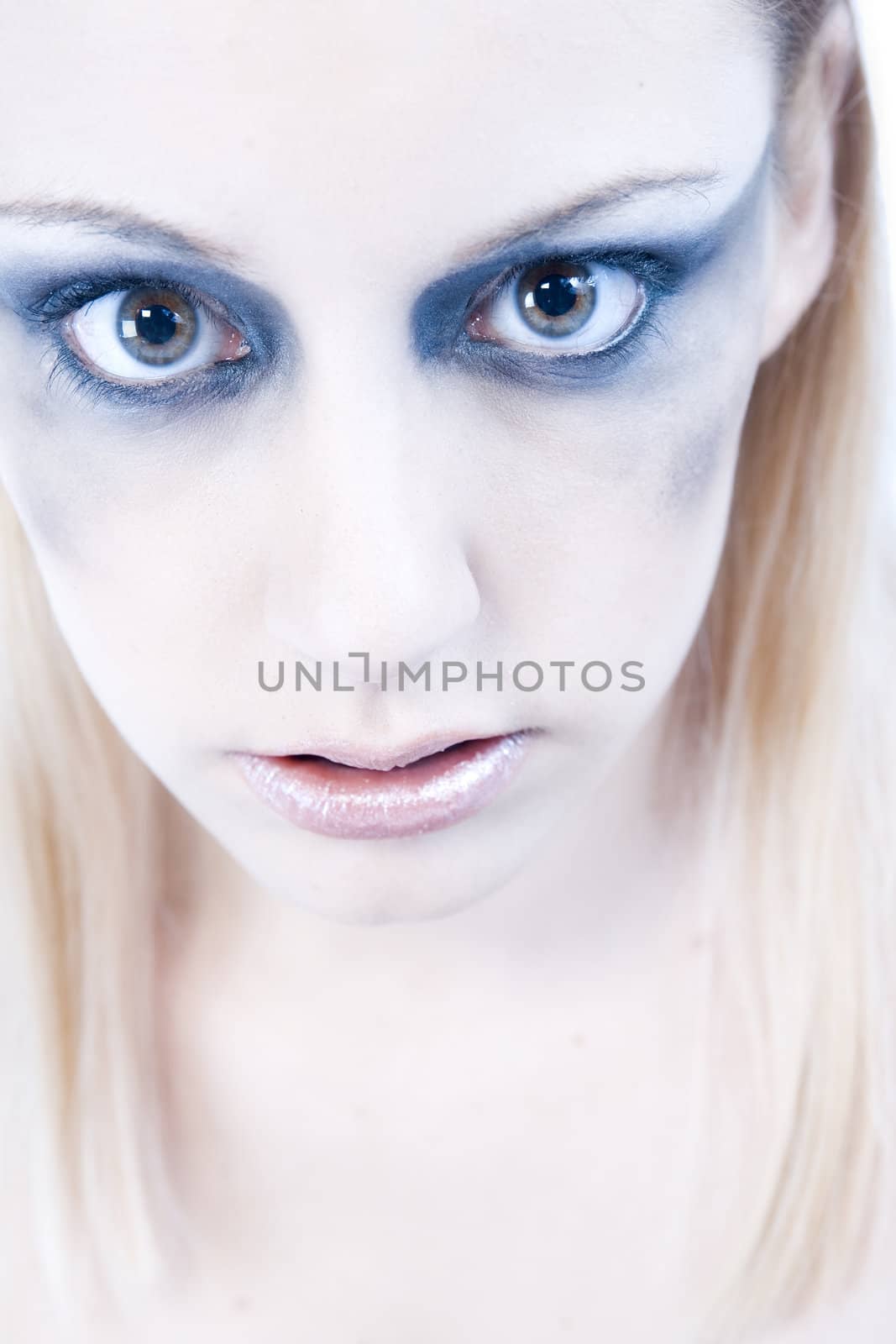 Studio portrait of a young blond woman looking scary