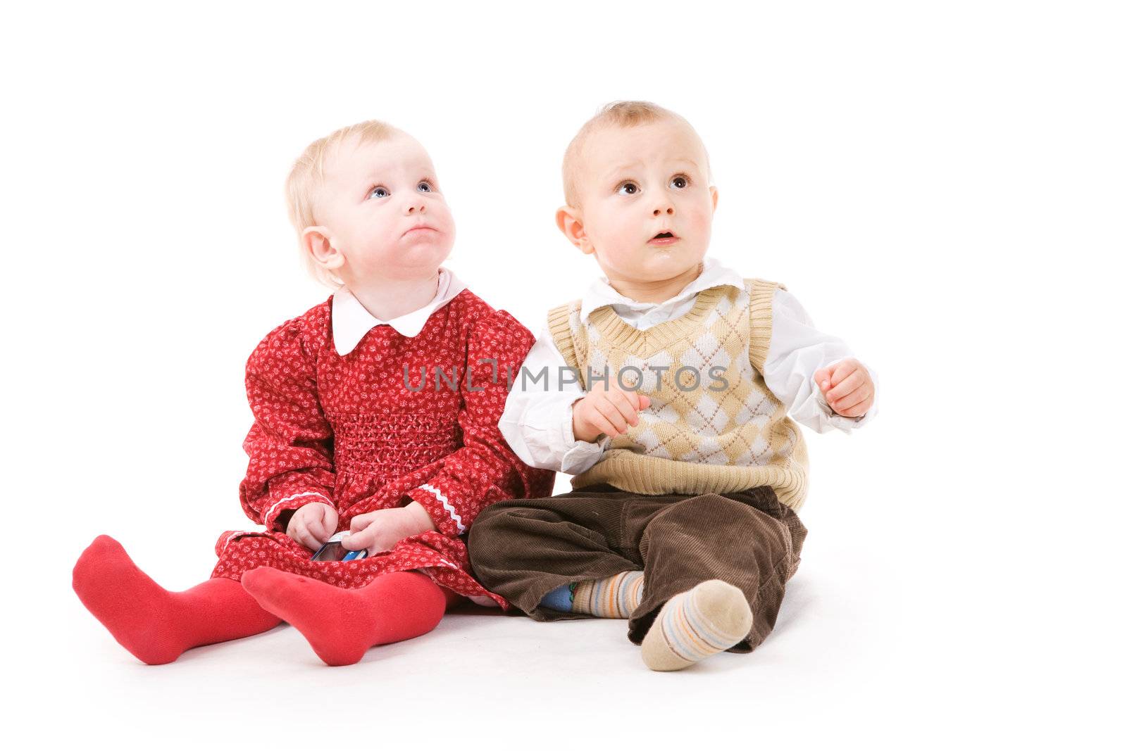 boy and girl of one year old look up