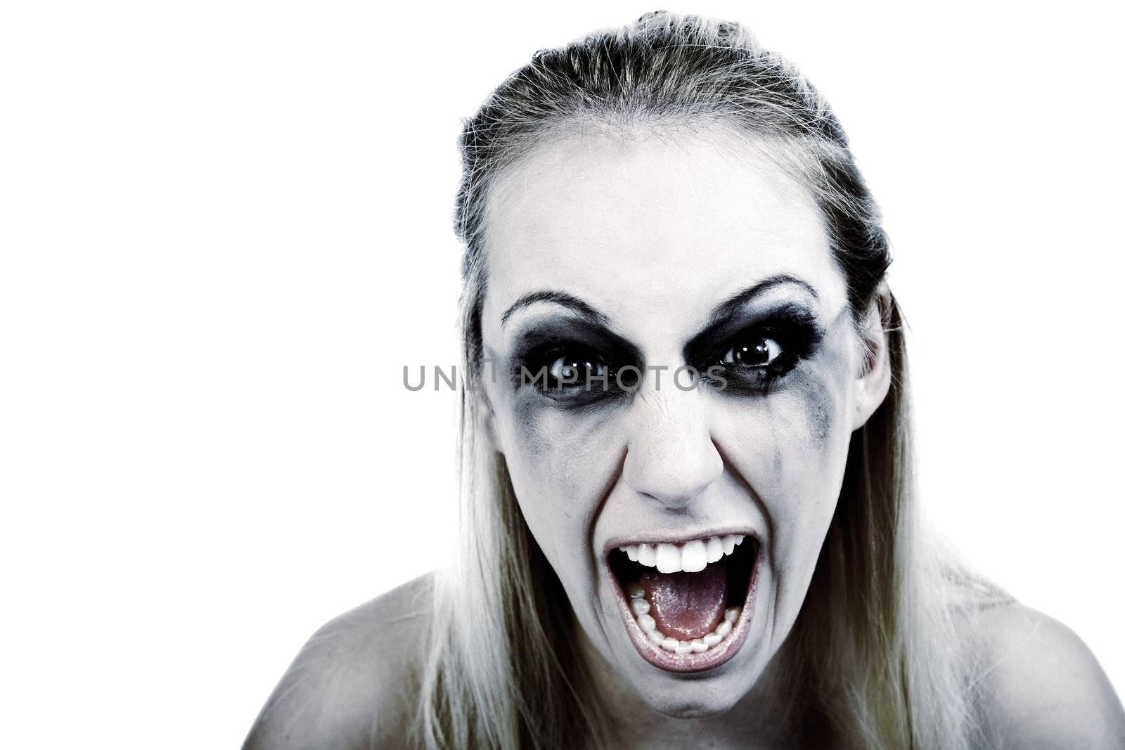 Studio portrait of a young blond woman in horror by DNFStyle