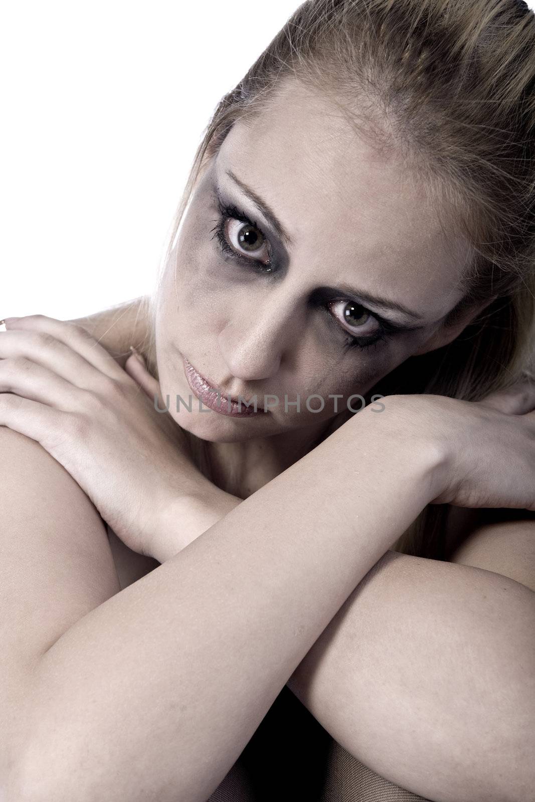 Studio portrait of a young blond woman looking hurt