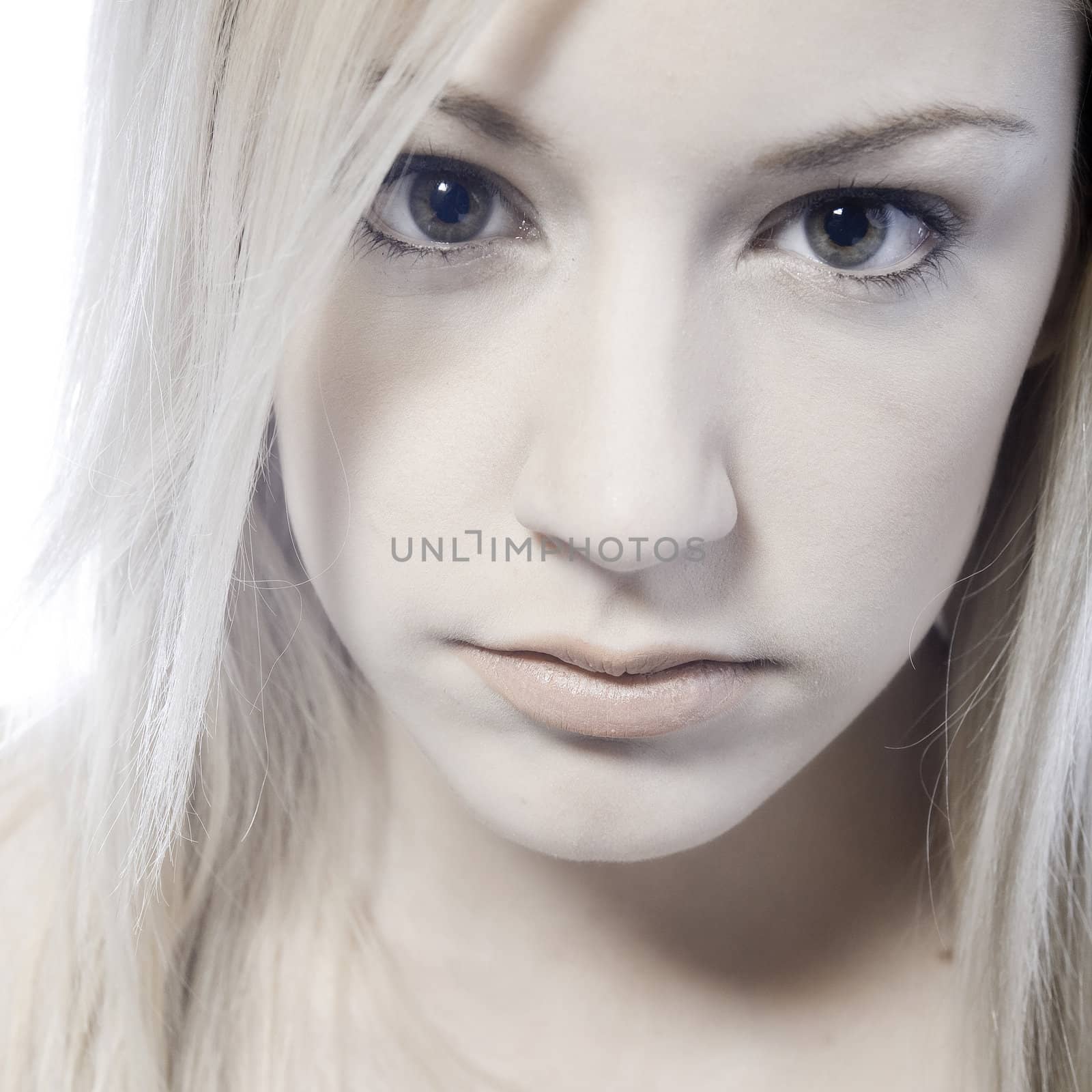 Studio portrait of a young blond woman pouting