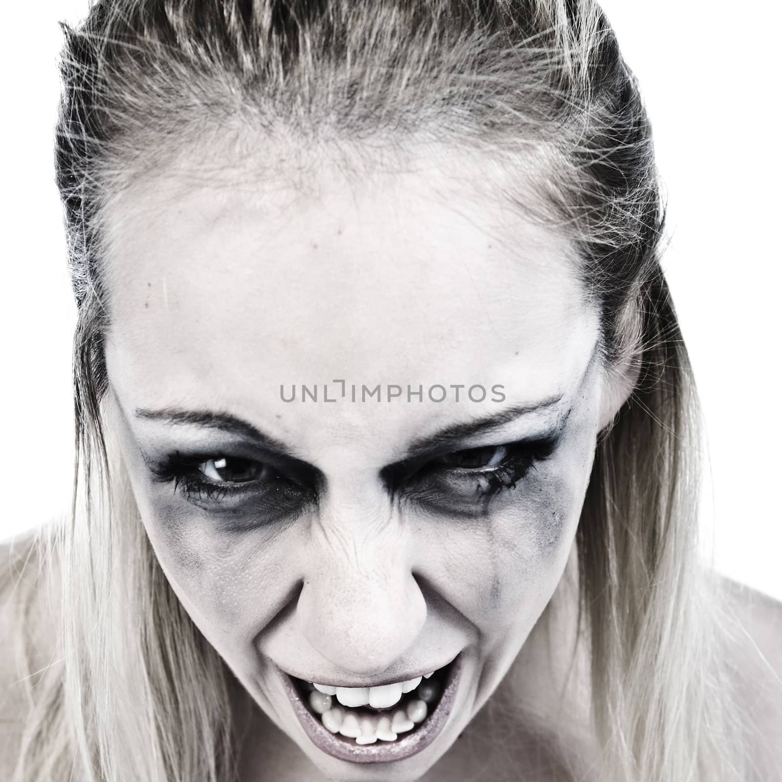 Studio portrait of a young blond woman looking scary