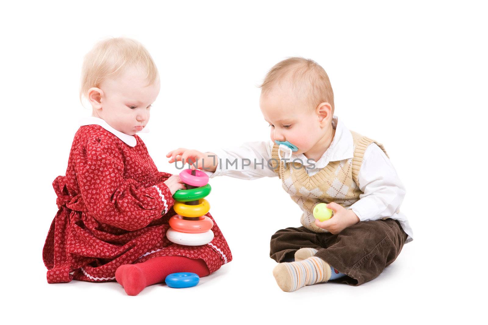 small children play development game pyramide on the floor