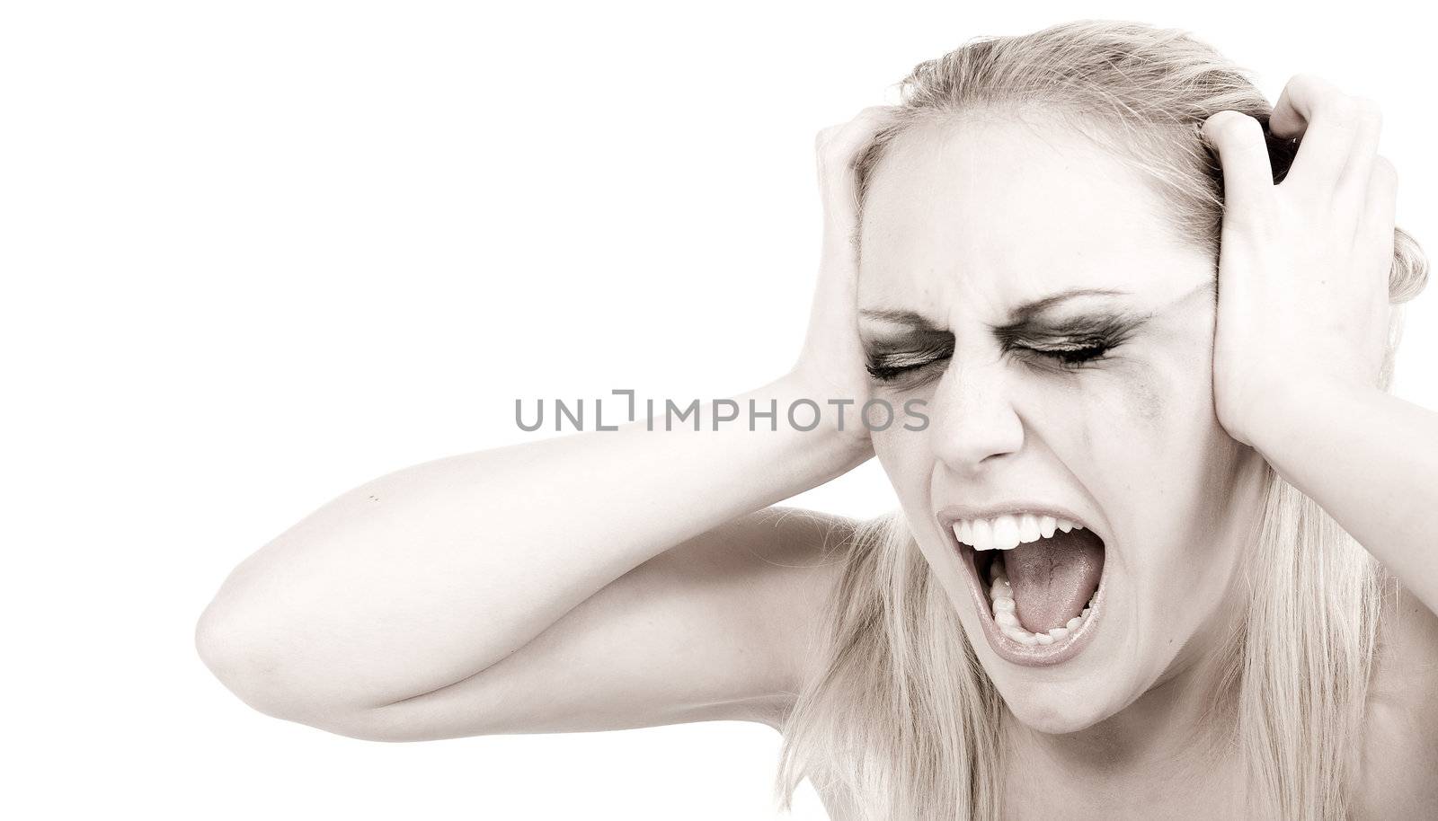 Studio portrait of a young blond woman in despair