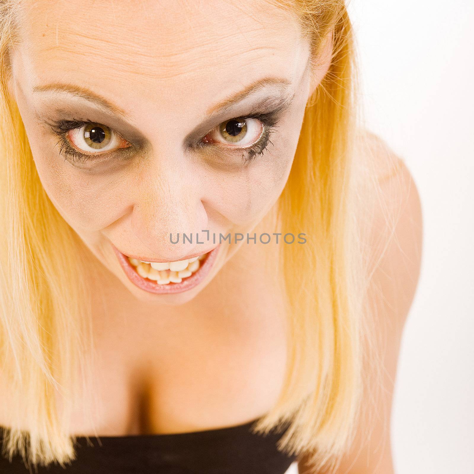 Studio portrait of a young blond woman looking crazy