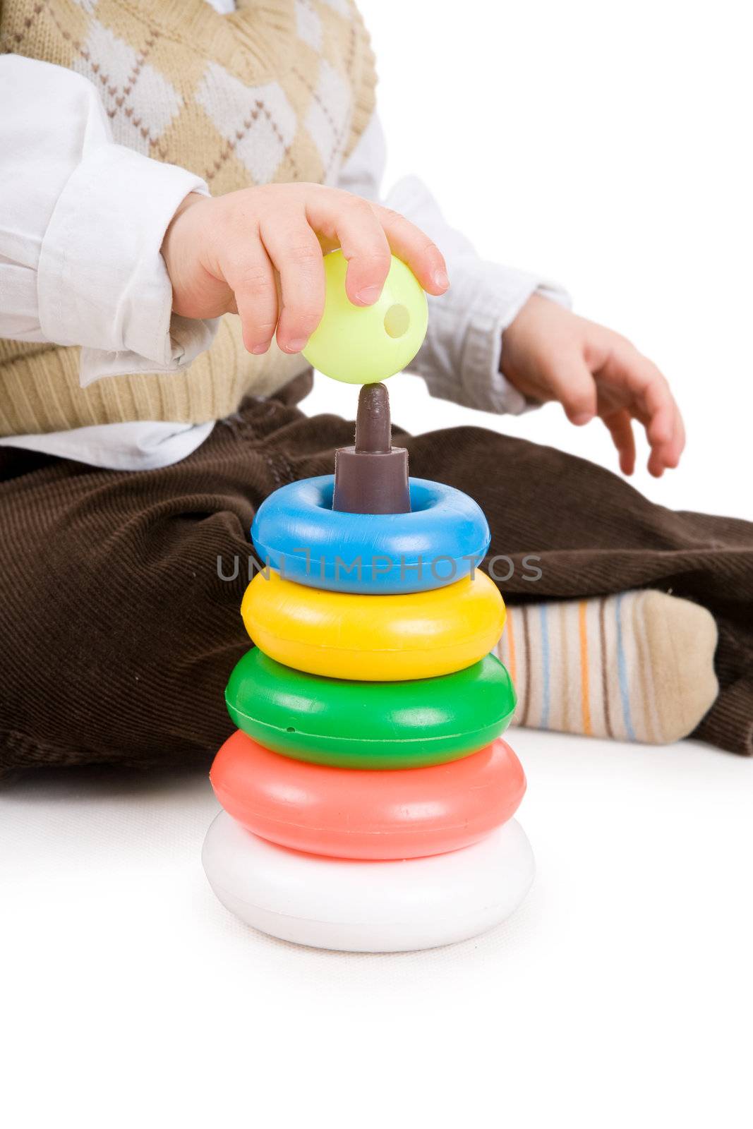 hand of toddler boy puts on a sphere on pyramidion by vsurkov