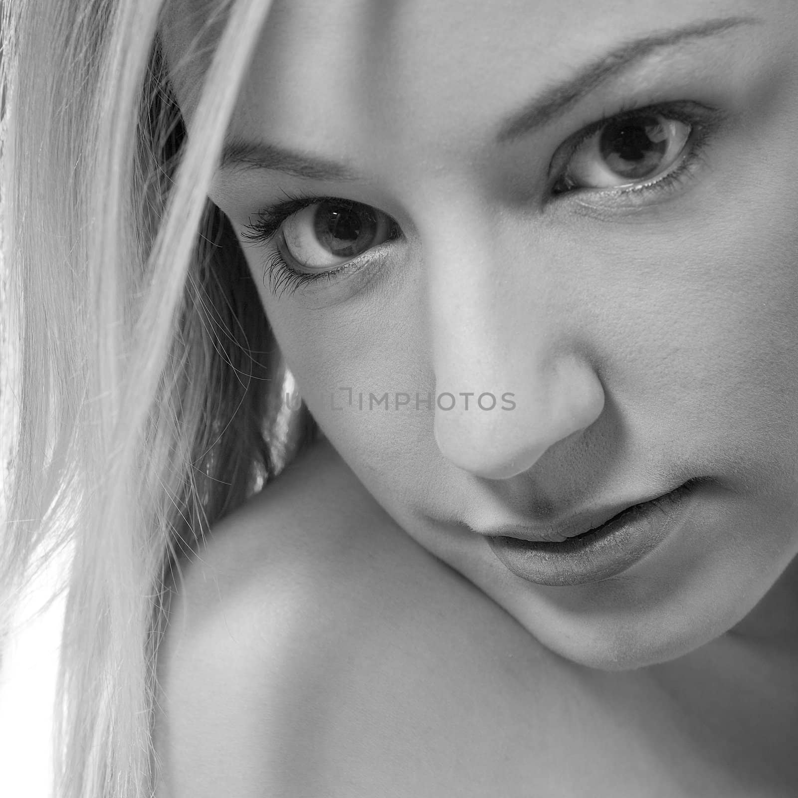 Studio portrait of a young blond woman in black and white by DNFStyle