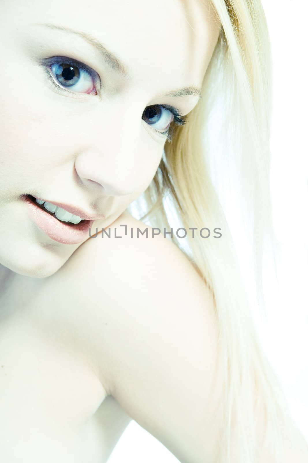 Acid processed studio portrait of a young blond woman 