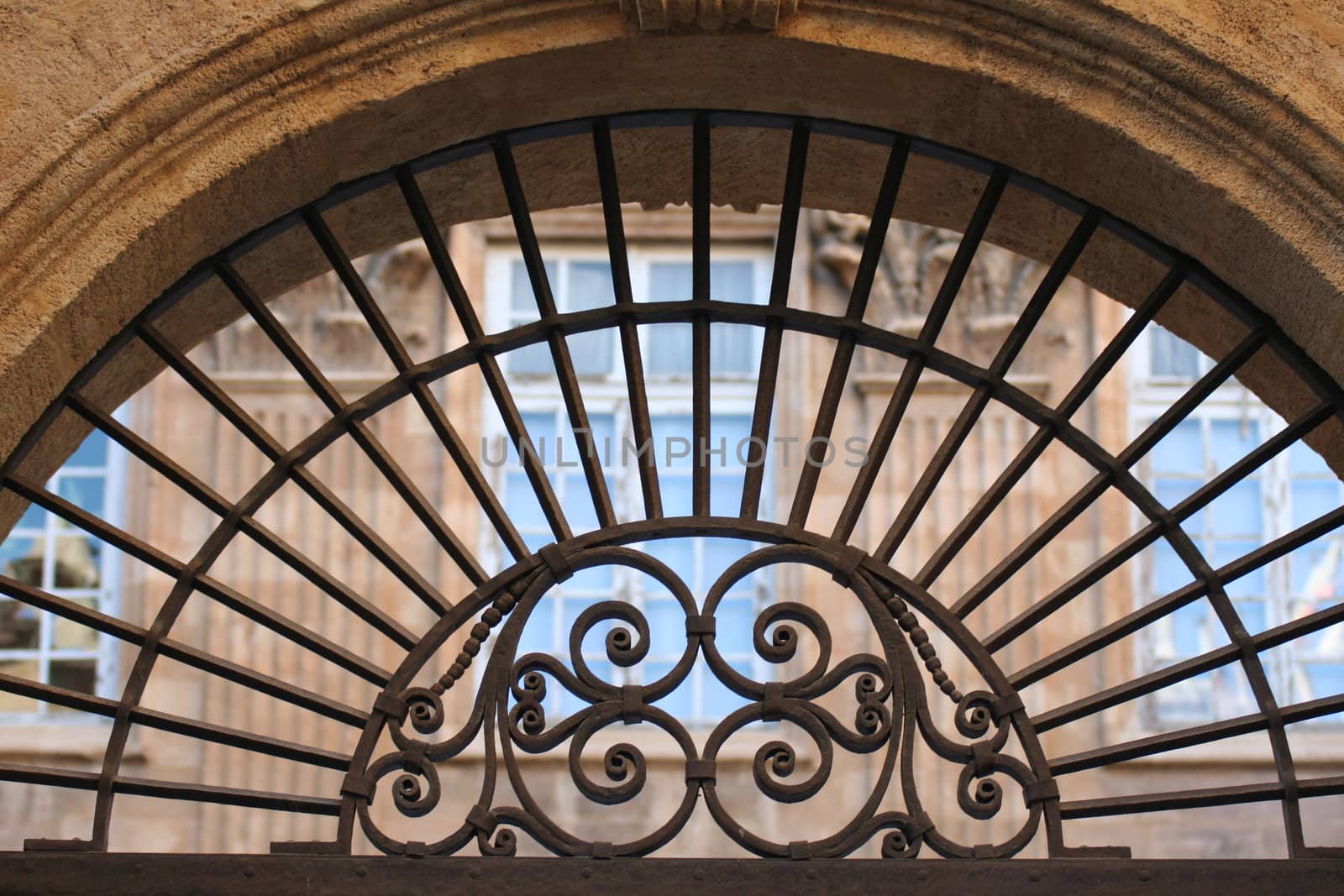 Ancient stylish iron ornament above an house's door