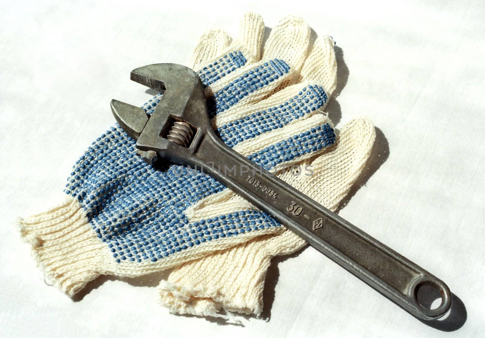 Two fabric gloves and adjustable spanner