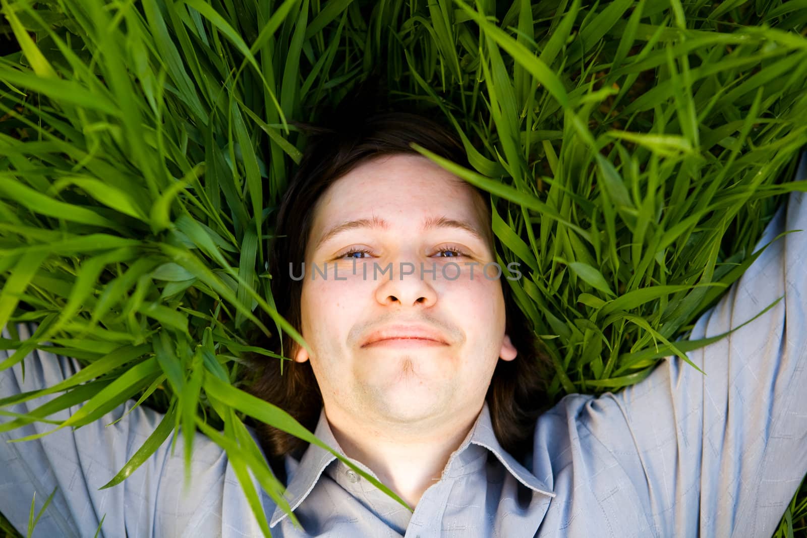 businessman rest on the green grass