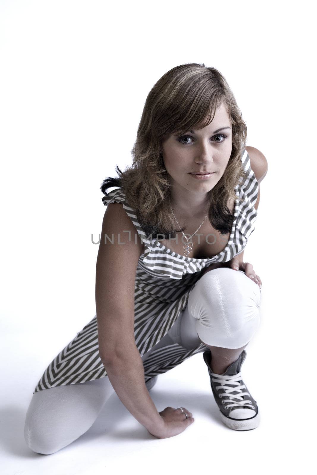 Studio portrait of a teenage model sitting on one knee