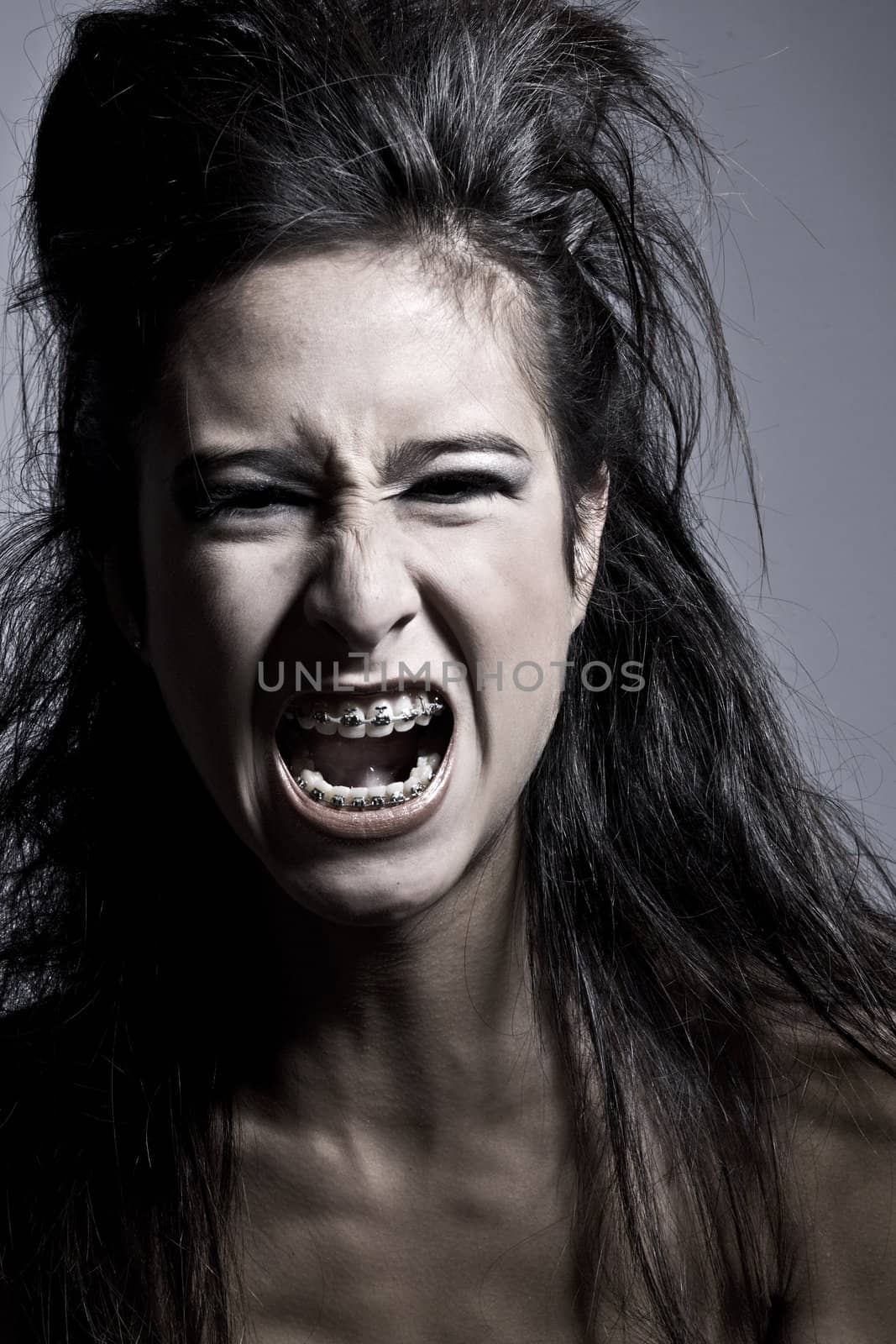 Studio portrait of an asian mixed raced teenager screaming out loud