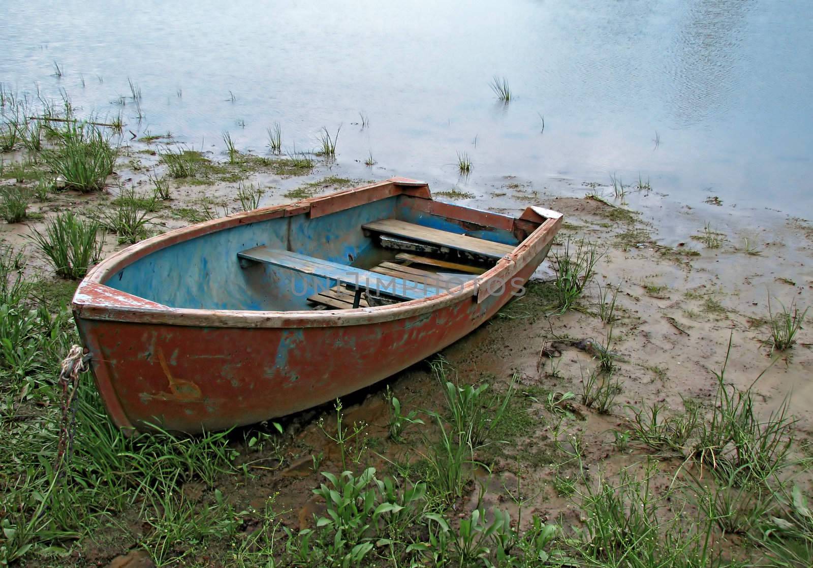 An abandoned boat on a bank of a river