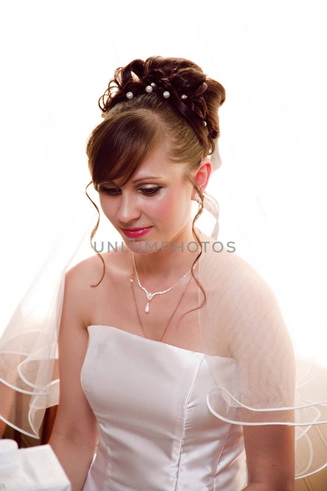 A beautiful portrait of a young bride in a white dress.
