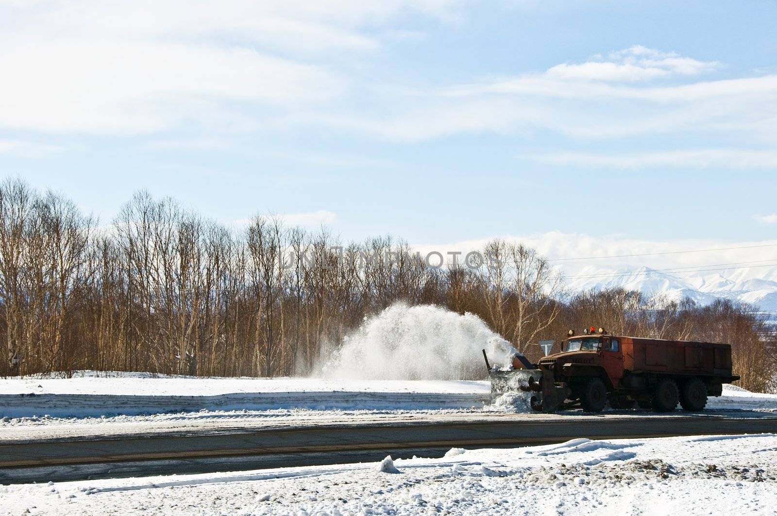 Snowplow removing snow from intercity snow road