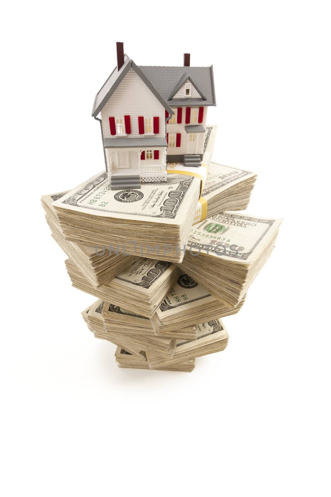 Small House on Stacks of Hundred Dollar Bills Isolated on a White Background.