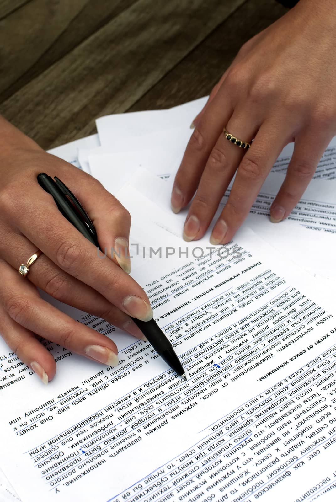 Close-up of female hands working with documents