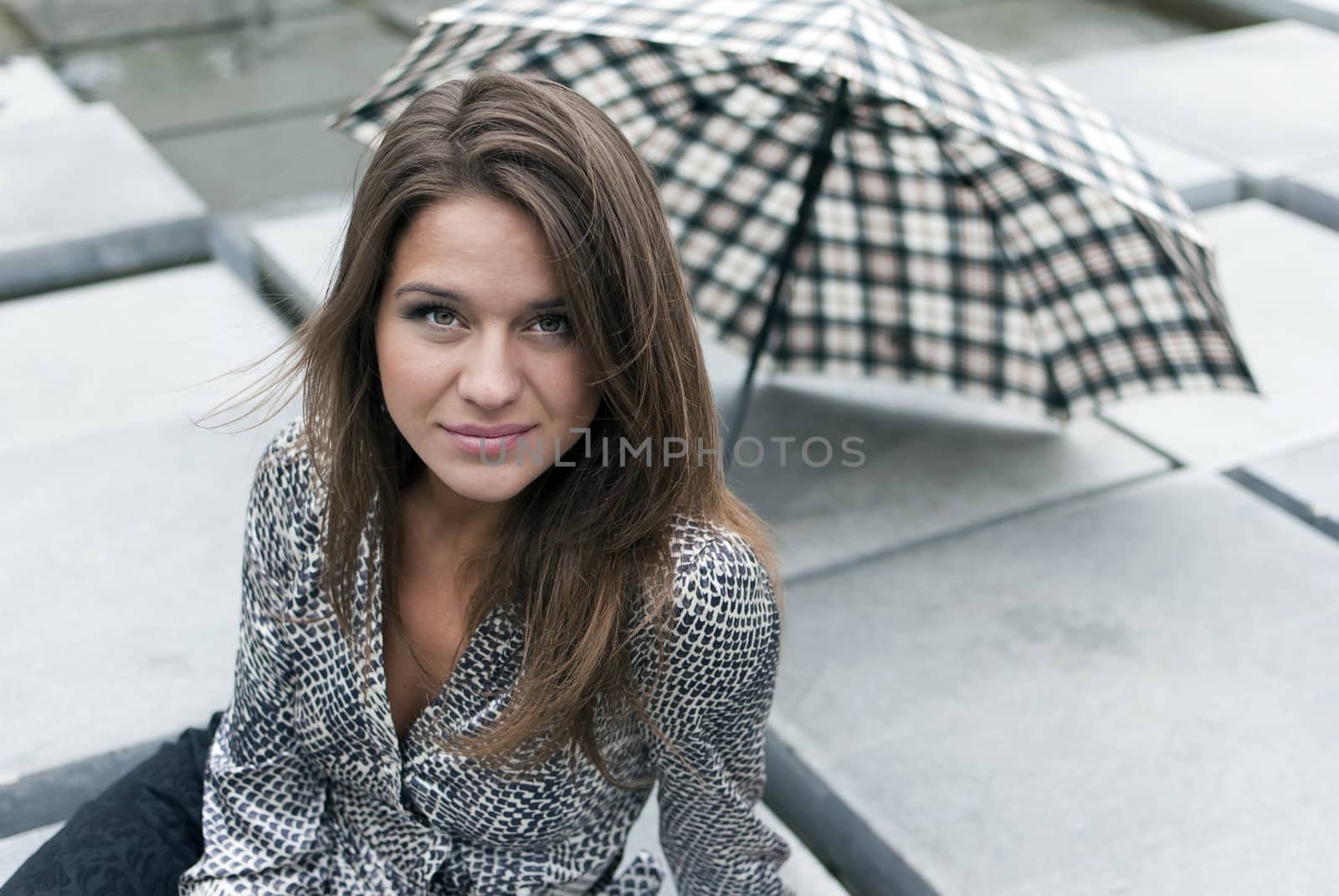 portrait of a beautiful girl with an umbrella on background