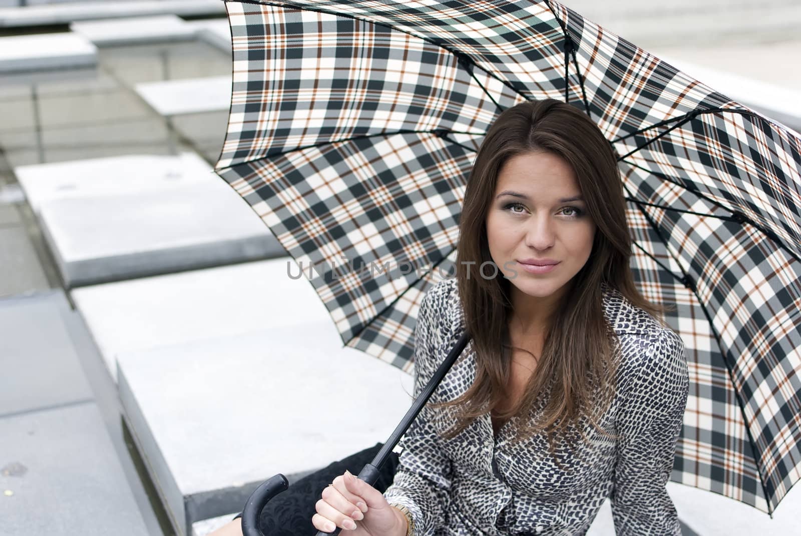 portrait of a beautiful girl with an umbrella on background