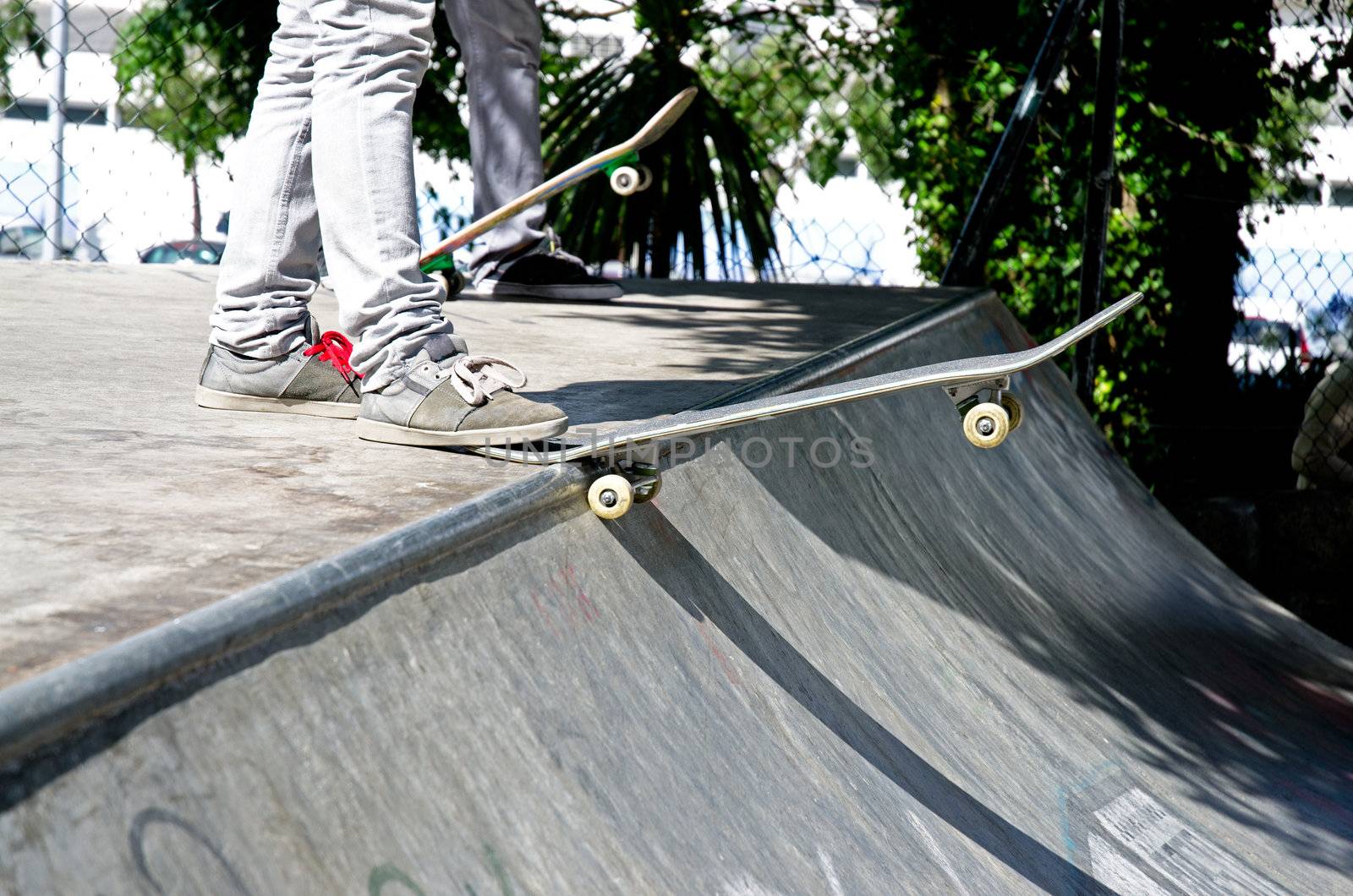 Skateboarders ready to drop in on a ramp
