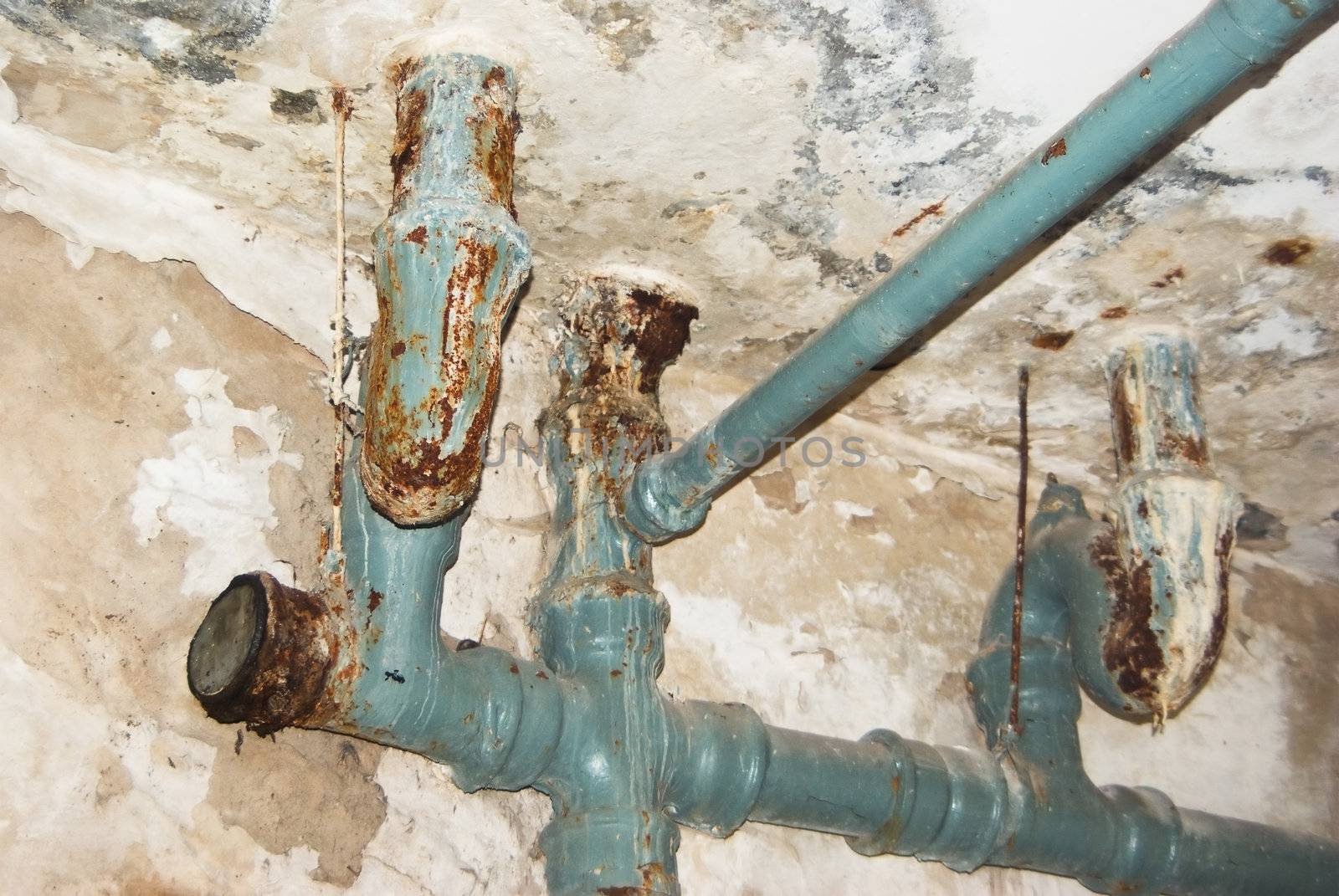 Pipes for the water drain on a background of a wall